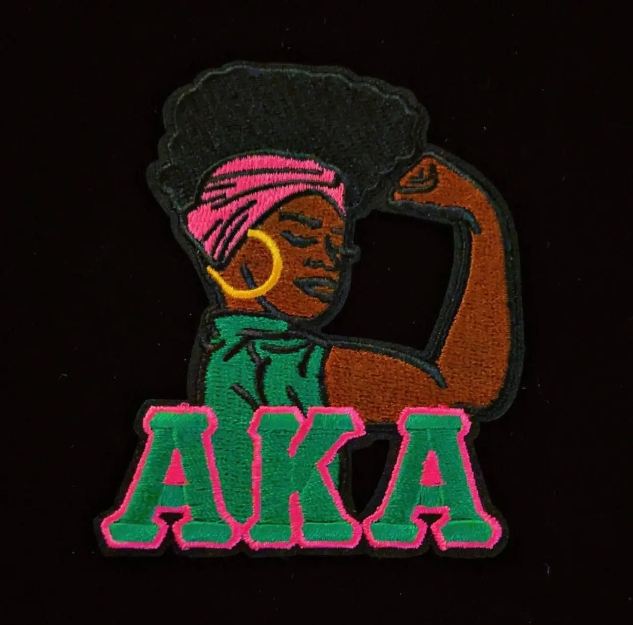 Embroidered patch of a strong woman flexing arm muscle, perfect for DIY fashion and statement apparel.