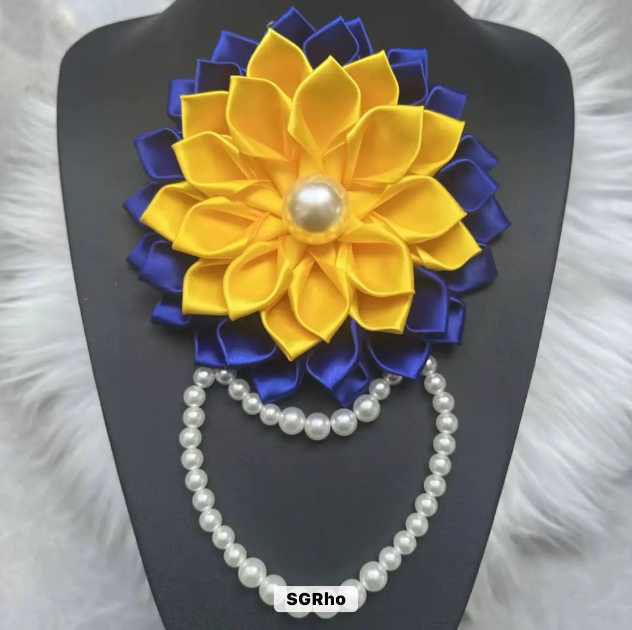 Elegant pearl brooch with blue and gold ribbon and flower accent, inspired by Sigma Gamma Rho sorority pride.