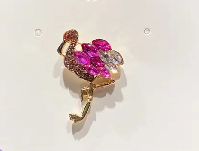 Pink and purple flamingo pin brooch with detailed feathers and an elegant neck design, perfect for adding a colorful, tropical touch to jackets, bags, hats, socks, or sneakers