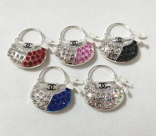 Luxurious silver metal and rhinestone purse charm with sparkling accents, perfect for keychains, focal pieces, and designer-inspired accessories. Ideal for DIY crafters, fashion enthusiasts, and luxury seekers creating custom jewelry, bag charms, and standout designs.