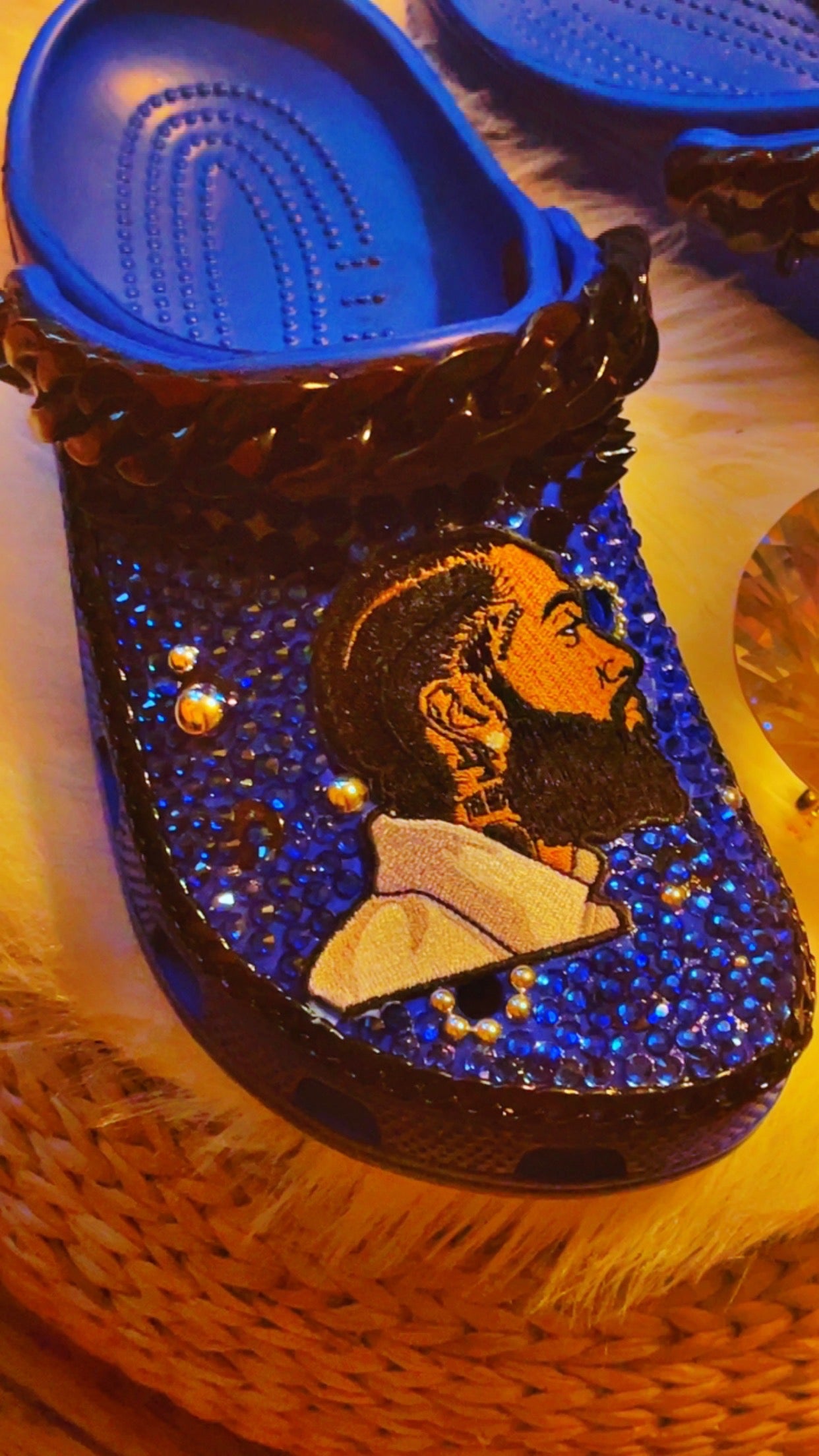 Step into Nipsey Hussle's legacy with our Blue Crocs. Featuring a Nipsey Hussle patch and iconic Jibbitz, these Crocs pay homage to the legendary artist. The sleek blue design and chic black accents add urban style to comfort. 🎵👟🌟 #NipseyHussle #CustomCrocs #FashionFootwear - Right Foot