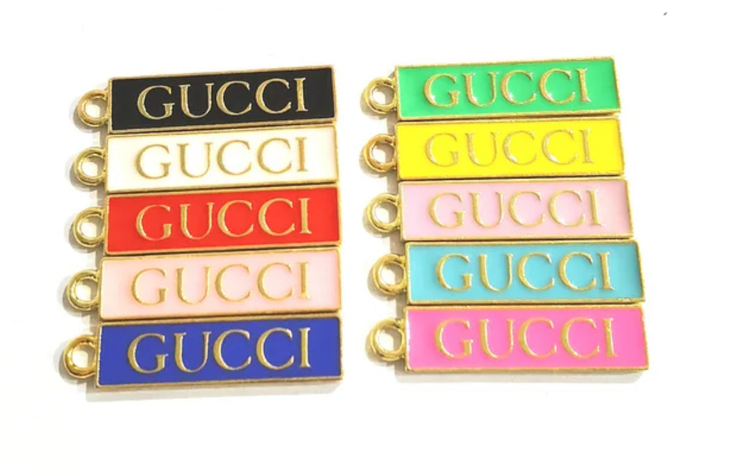 Gold GUCCI TAG CHARM – Designer-inspired alloy charm for customizing bracelets, keychains, shoes, and more. Add a touch of luxury to your personalized fashion creations. 